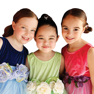 Three girls dressed up in fancy dresses for a Snip-its glam party.