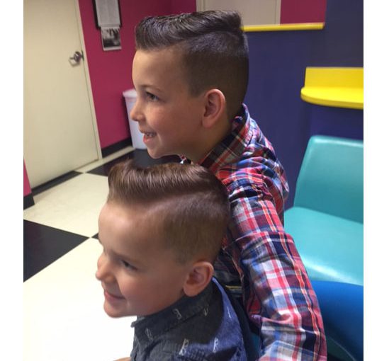 Two boys showing off their Pompadour haircuts from Snip-its.