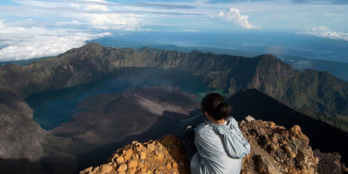 A person with a beautiful eagle's eye view of the mountains and sky.