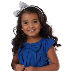 girl in blue dress with bow headband and pierced ears